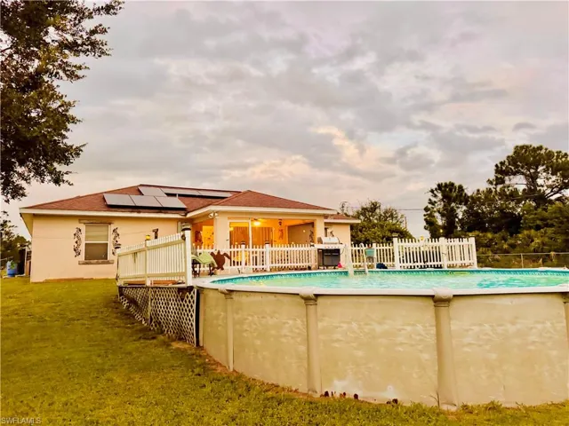 View of swimming pool with a patio area and a deck