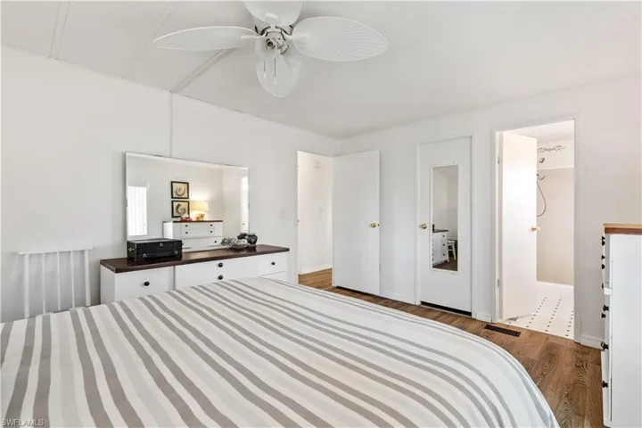 Bedroom featuring, connected bathroom, and a ceiling fan