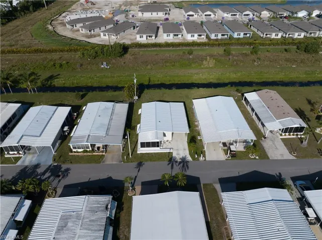 Aerial overview of property's location with nearby suburban area and a nearby body of water