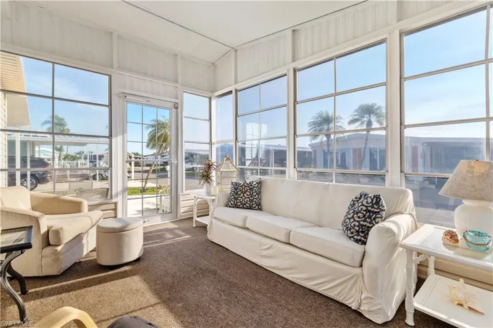 Sunroom / solarium featuring carpet floors
