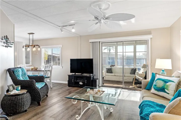 Living area featuring, a ceiling fan, and track lighting