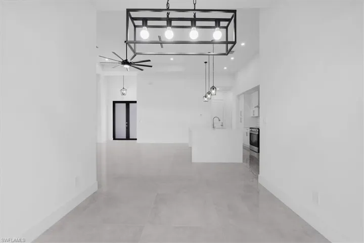 Hallway with sink and a high ceiling