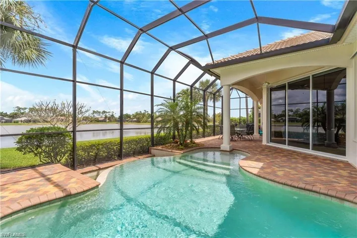 Swimming pool featuring a sunroom, a lanai, a patio, a water view, and outdoor dining area