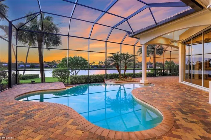 Pool with infinity edge and generous patio area under screen