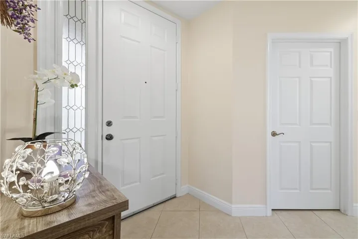 Entryway featuring light tile patterned floors and baseboards