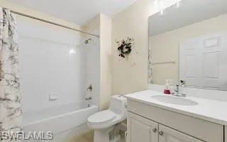 Bathroom featuring vanity, bathing tub / shower combination, and light tile patterned floors