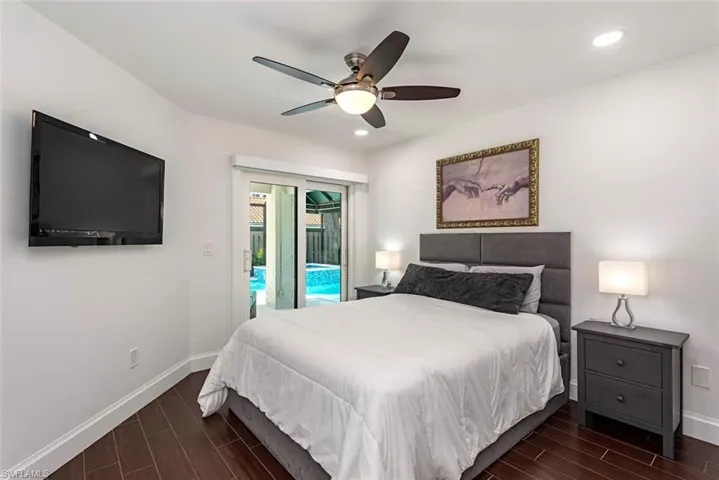Bedroom featuring wood tiled floors, access to exterior, ceiling fan, and recessed lighting