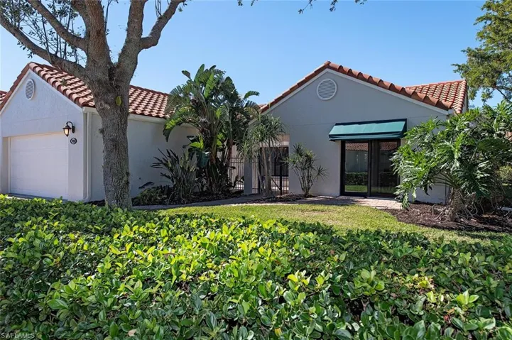 Mediterranean / spanish house featuring a tiled roof, stucco siding, and a garage