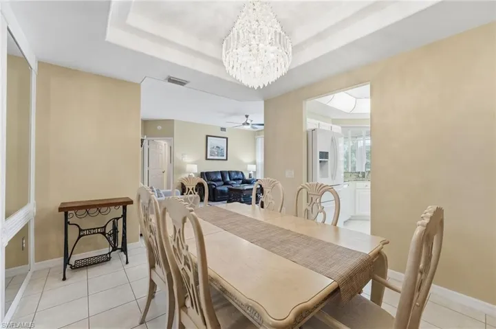 The formal dining area features a double tray ceiling accented by a gorgeous chandelier.