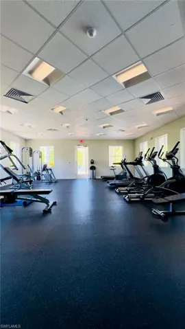 Exercise room with visible vents and a paneled ceiling