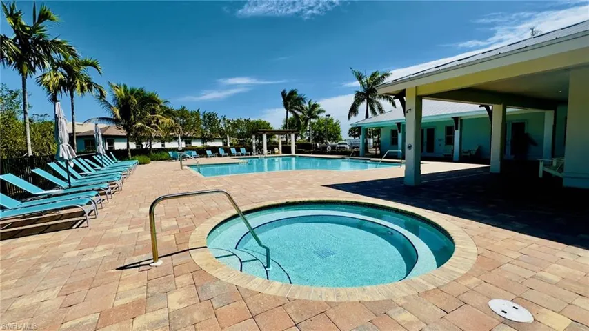 Community pool featuring a community hot tub and a patio area