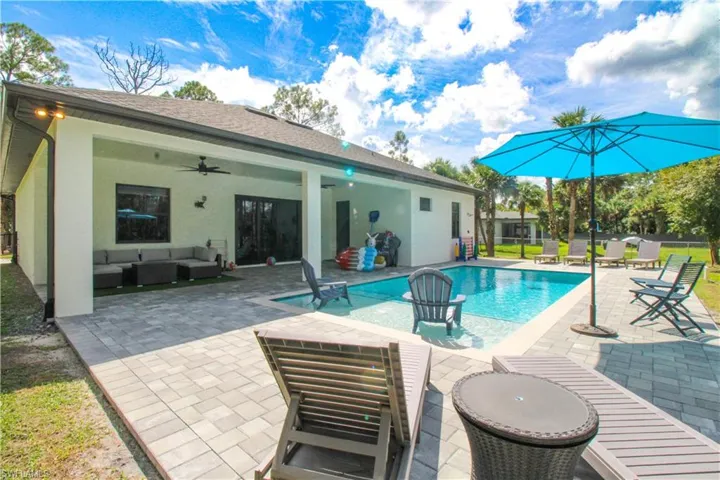 View of pool featuring ceiling fan, an outdoor hangout area, and a patio