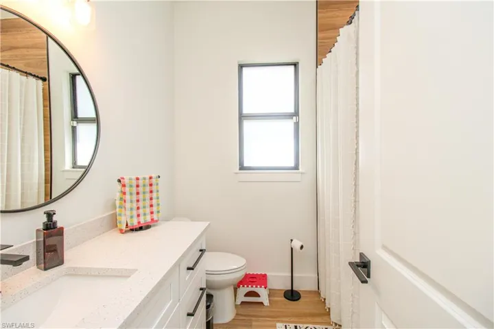 Bathroom 3 featuring hardwood / wood-style floors, vanity, and toilet