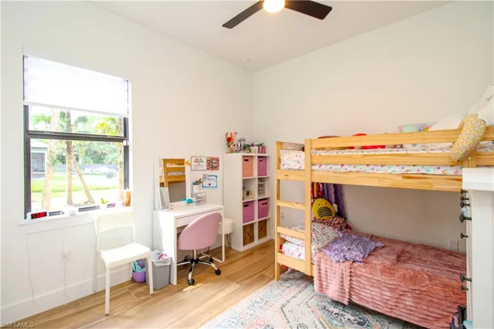 Bedroom 4 with hardwood / wood-style floors and ceiling fan