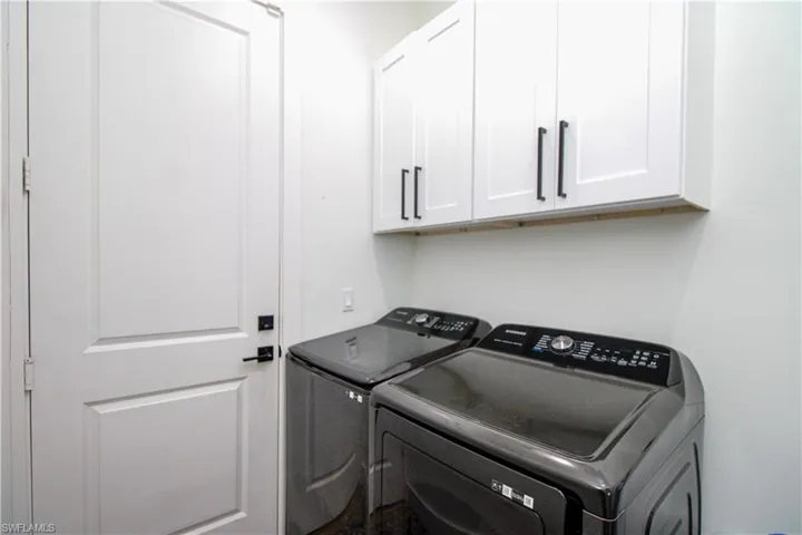 Clothes washing area with independent washer and dryer and cabinets