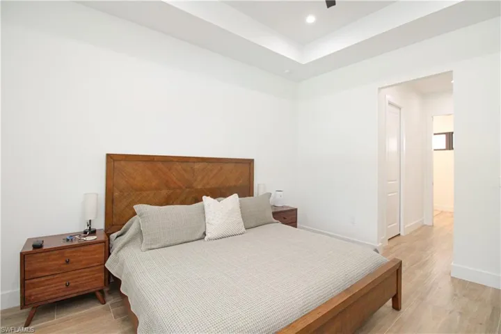 Bedroom with light hardwood / wood-style floors and ceiling fan