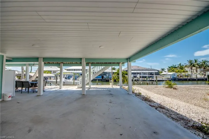 Covered concrete patio with waterfront access