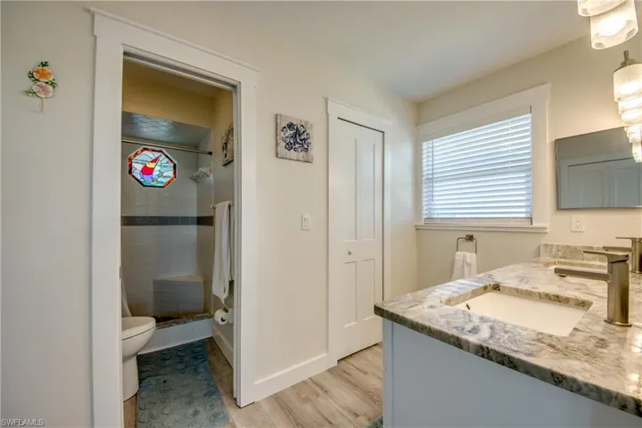 Bathroom featuring a double vanity with stone countertops, undermount sinks, and brushed nickel fixtures