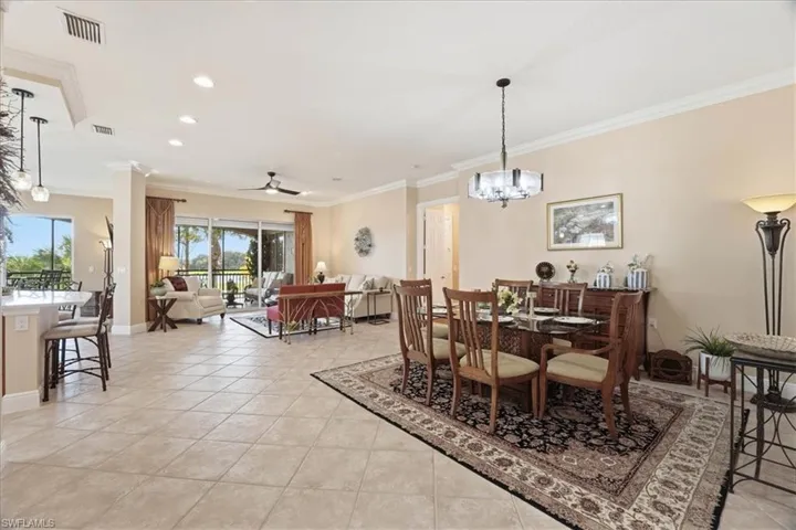 Dining room with a ceiling fan, a chandelier, ornamental molding, recessed lighting, and light tile patterned floors