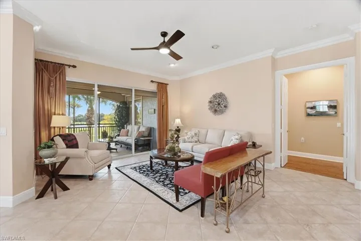 Living room featuring ornamental molding, ceiling fan, light tile patterned floors, and recessed lighting