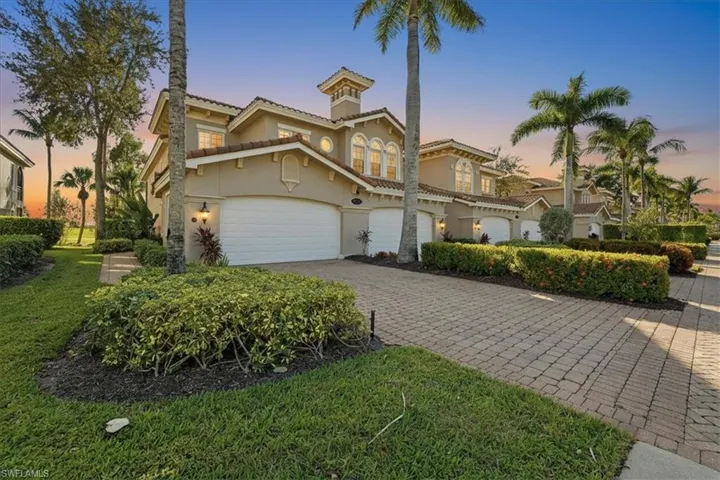 Mediterranean / spanish-style home featuring stucco siding, decorative driveway, a tiled roof, and a front yard