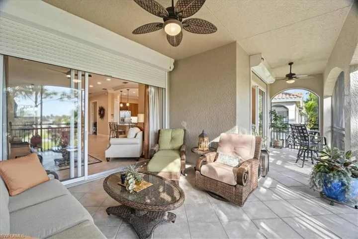 View of patio with a ceiling fan and an outdoor living space