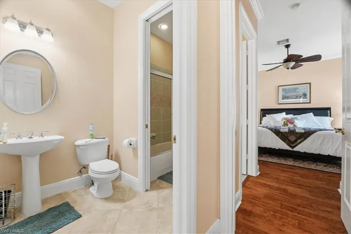 Bathroom featuring tub / shower combination, ceiling fan, and ensuite bath