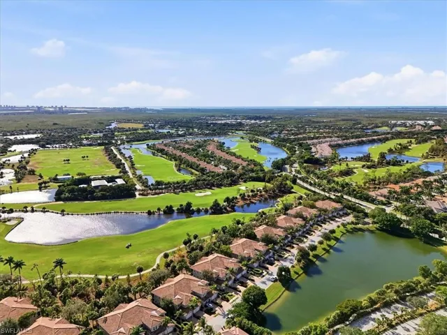 Aerial view of residential area with a large body of water and a golf course