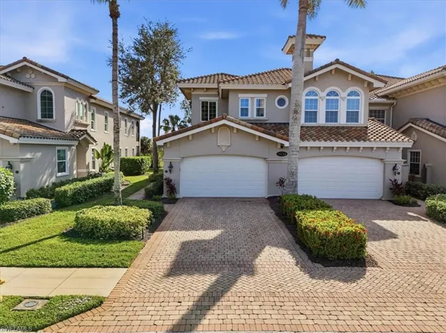 Mediterranean / spanish-style house featuring stucco siding, decorative driveway, a tiled roof, and a garage