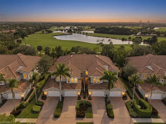 Aerial view at dusk of a water view, golf course view, and a residential view