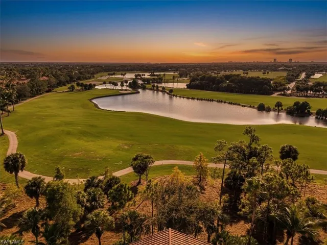 Aerial view at dusk of a water view and view of golf course