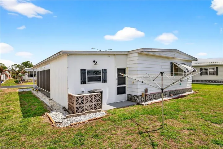 Back of property featuring a yard