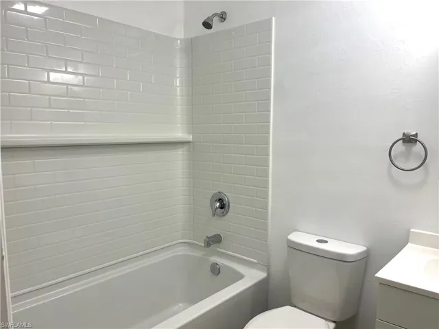 Bathroom with shower / bath combination and vanity
