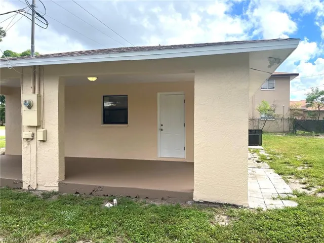 Doorway to property with stucco siding