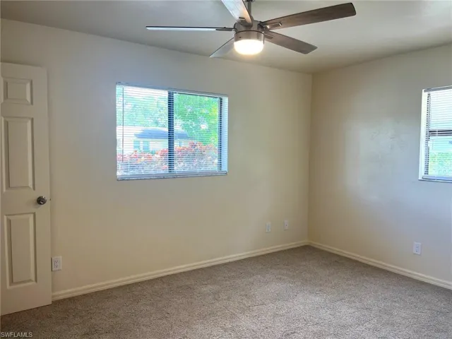 Spare room with carpet flooring and a ceiling fan