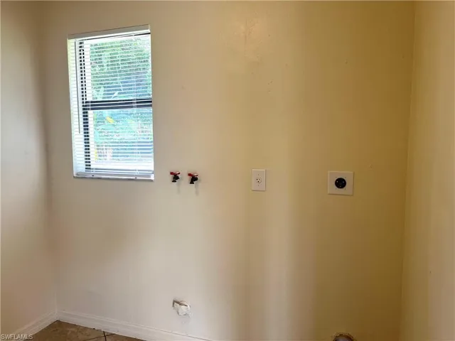 Washroom featuring washer hookup and tile patterned floors