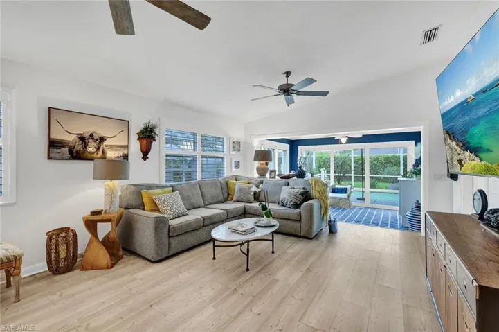 Vaulted ceilings, wood-finish flooring, ceiling fan, and sliding glass doors