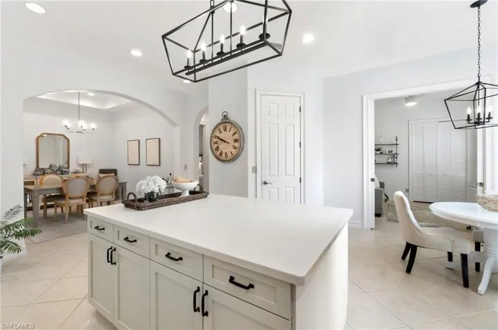 Kitchen featuring recessed lighting, light tile patterned flooring, and an inviting chandelier