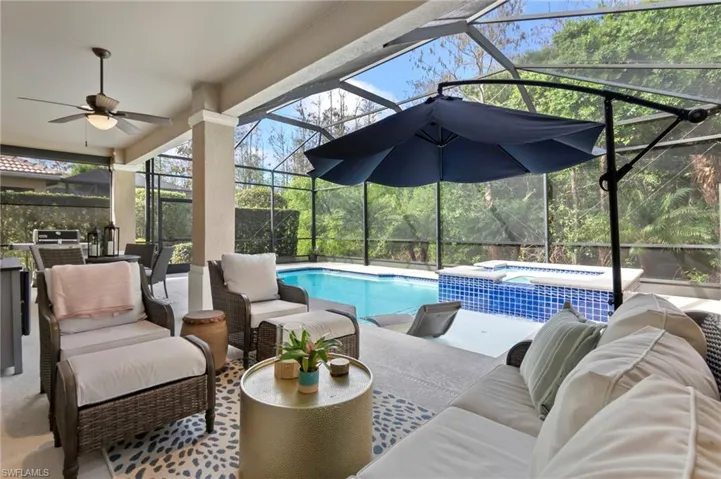 View of pool with ceiling fan, a patio, a lanai, and an outdoor living space