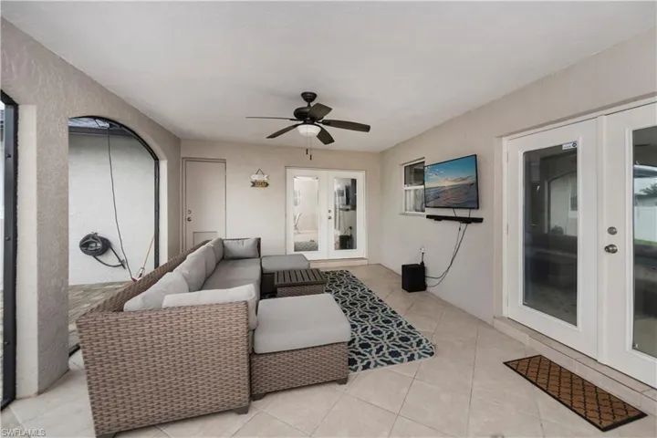 View of terrace featuring ceiling fan and french doors