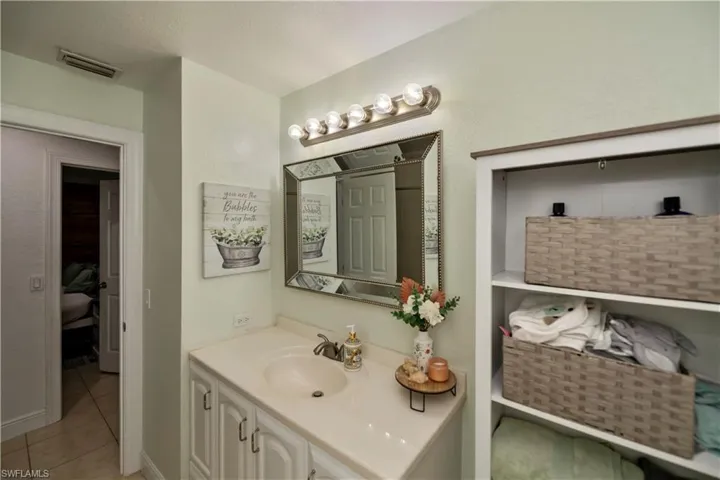 Bathroom featuring tile flooring and vanity