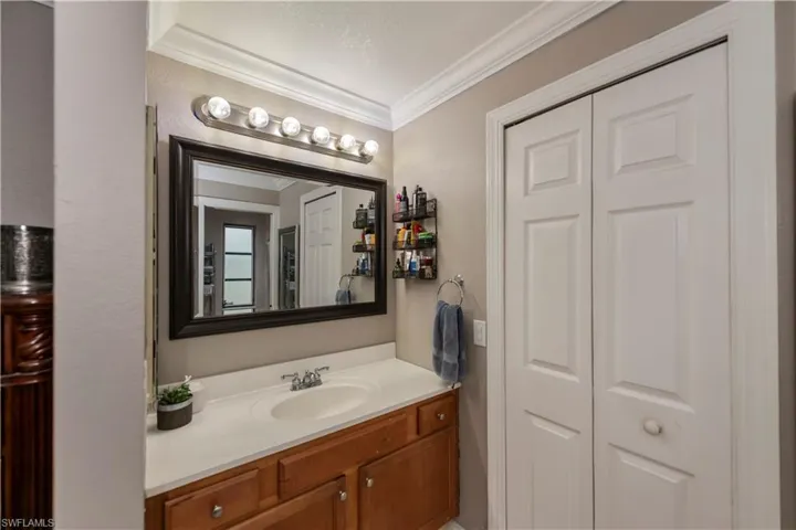 Bathroom with vanity and crown molding