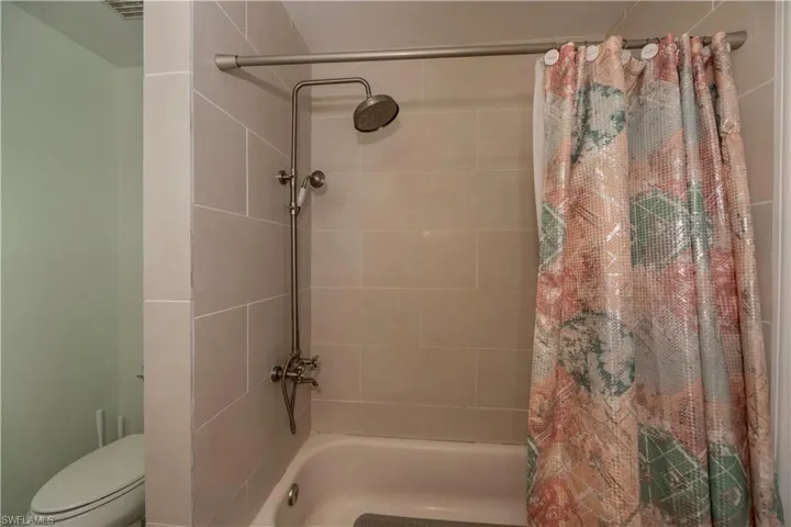 Bathroom with shower / tub combo and toilet