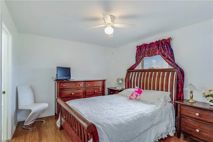 Bedroom with wood finished floors and a ceiling fan