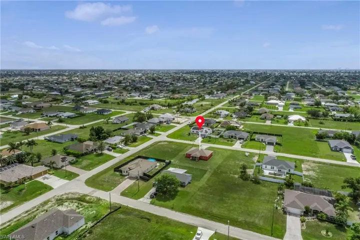 Aerial view of property and surrounding area with nearby suburban area
