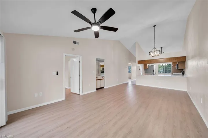 Living room with kitchen view, Vaulted ceiling, new baseboards and flooring