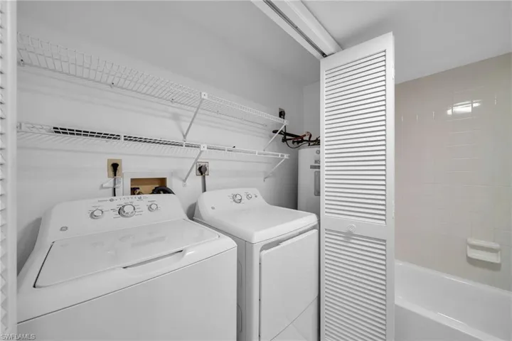 Laundry area with washing machine and clothes dryer in Guest Bathroom