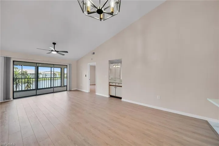 Living and Dining Room with Big Lake View, High Vaulted Ceiling, New lighting, Floors, baseboards, Designer Paint and New Ceiling Fan