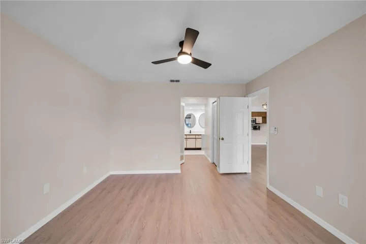 Master Bedroom looking into master bathroom off living room. New floors, Baseboards, Designer Paint and lighting With a Huge Lake View
