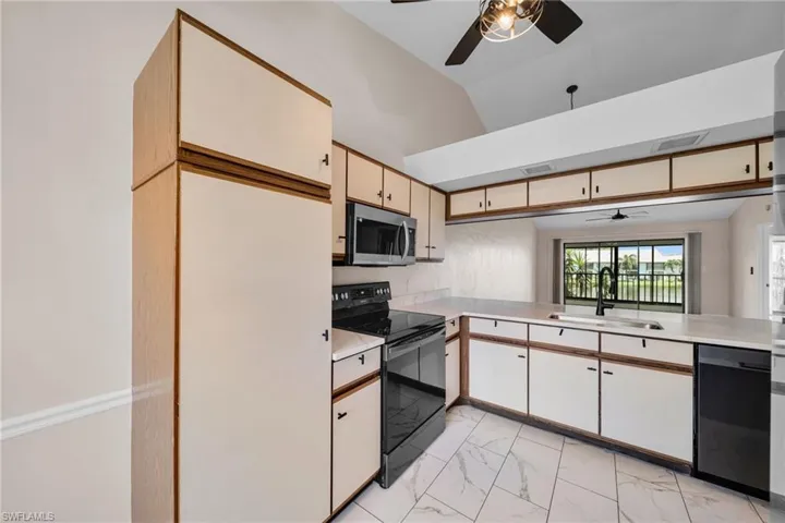 Kitchen with Newer appliances, tile flooring, new lighting, Granite counters and Big Lake View ~ Bonus eat in kitchen